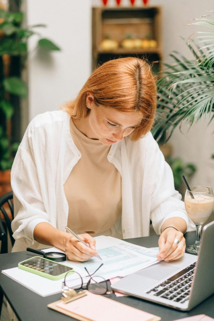 Small business owner planning which administrative tasks to delegate to virtual assistant for time management