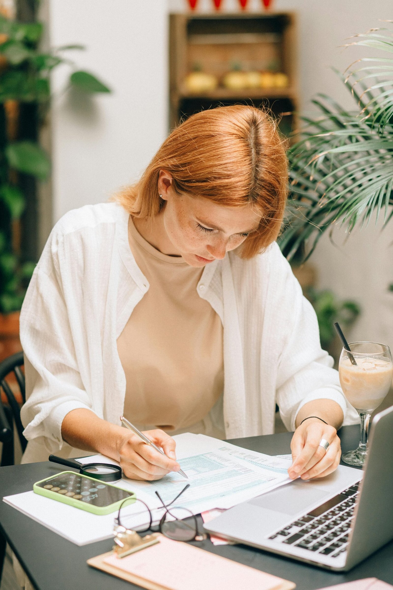 Small business owner planning which administrative tasks to delegate to virtual assistant for time management
