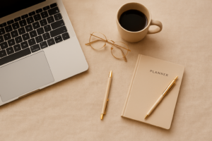 Minimal workspace with planner and coffee mug on beige background